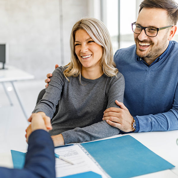 Happy couple came to an agreement with their financial advisor in the office